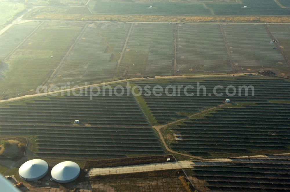 Aerial photograph Köthen - Blick auf den Solarpark. Auf einer Fläche von 55 Hektar ist es das bundesweit zweitgrößte Photovoltaik-Kraftwerk und wurde 2008 in Betrieb genommen. Die hochmoderne PV-Anlage besteht aus ca. 200.000 dünnschicht Solarmodulen der Firma First Solar. Betrieben wird das Feld von der juwi solar GmbH. Kontakt: juwi Holding AG, Energie-Allee 1, 55286 Wörrstadt, Tel. 06732 / 96 57- 0,