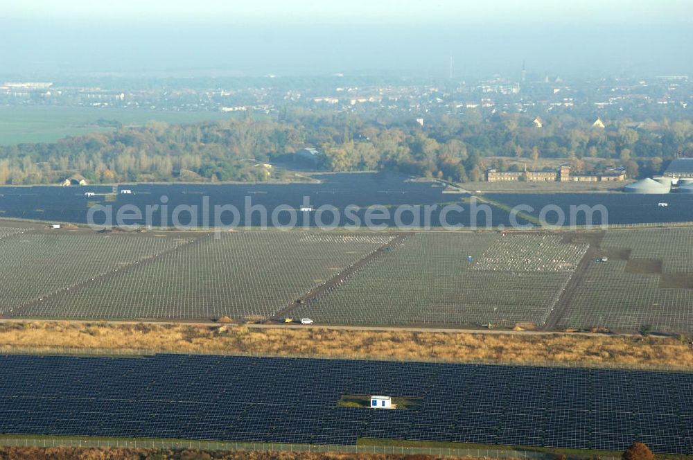 Aerial photograph Köthen - Blick auf den Solarpark. Auf einer Fläche von 55 Hektar ist es das bundesweit zweitgrößte Photovoltaik-Kraftwerk und wurde 2008 in Betrieb genommen. Die hochmoderne PV-Anlage besteht aus ca. 200.000 dünnschicht Solarmodulen der Firma First Solar. Betrieben wird das Feld von der juwi solar GmbH. Kontakt: juwi Holding AG, Energie-Allee 1, 55286 Wörrstadt, Tel. 06732 / 96 57- 0,