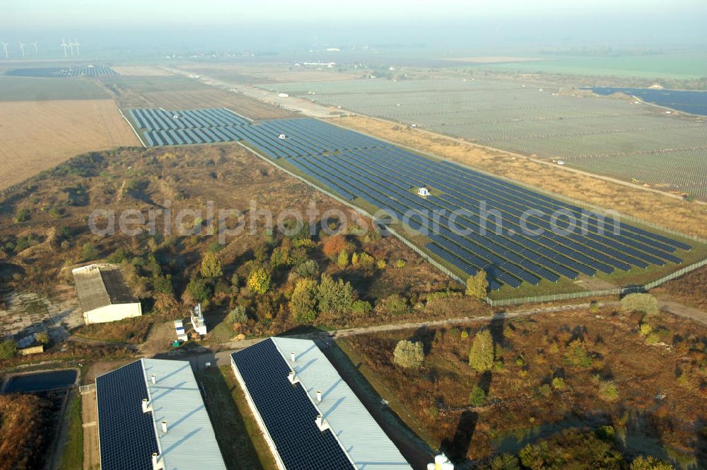 Aerial image Köthen - Blick auf den Solarpark. Auf einer Fläche von 55 Hektar ist es das bundesweit zweitgrößte Photovoltaik-Kraftwerk und wurde 2008 in Betrieb genommen. Die hochmoderne PV-Anlage besteht aus ca. 200.000 dünnschicht Solarmodulen der Firma First Solar. Betrieben wird das Feld von der juwi solar GmbH. Kontakt: juwi Holding AG, Energie-Allee 1, 55286 Wörrstadt, Tel. 06732 / 96 57- 0,