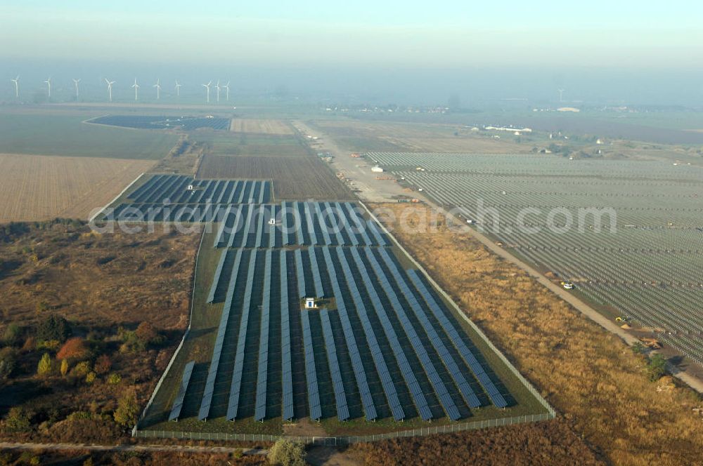 Aerial photograph Köthen - Blick auf den Solarpark. Auf einer Fläche von 55 Hektar ist es das bundesweit zweitgrößte Photovoltaik-Kraftwerk und wurde 2008 in Betrieb genommen. Die hochmoderne PV-Anlage besteht aus ca. 200.000 dünnschicht Solarmodulen der Firma First Solar. Betrieben wird das Feld von der juwi solar GmbH. Kontakt: juwi Holding AG, Energie-Allee 1, 55286 Wörrstadt, Tel. 06732 / 96 57- 0,