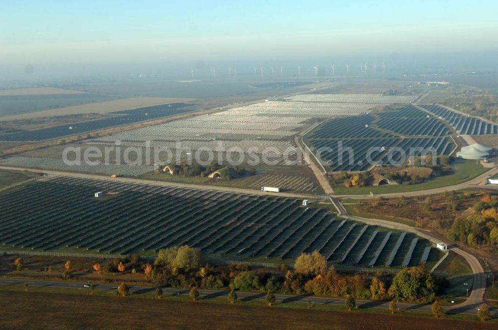 Aerial photograph Köthen - Blick auf den Solarpark. Auf einer Fläche von 55 Hektar ist es das bundesweit zweitgrößte Photovoltaik-Kraftwerk und wurde 2008 in Betrieb genommen. Die hochmoderne PV-Anlage besteht aus ca. 200.000 dünnschicht Solarmodulen der Firma First Solar. Betrieben wird das Feld von der juwi solar GmbH. Kontakt: juwi Holding AG, Energie-Allee 1, 55286 Wörrstadt, Tel. 06732 / 96 57- 0,