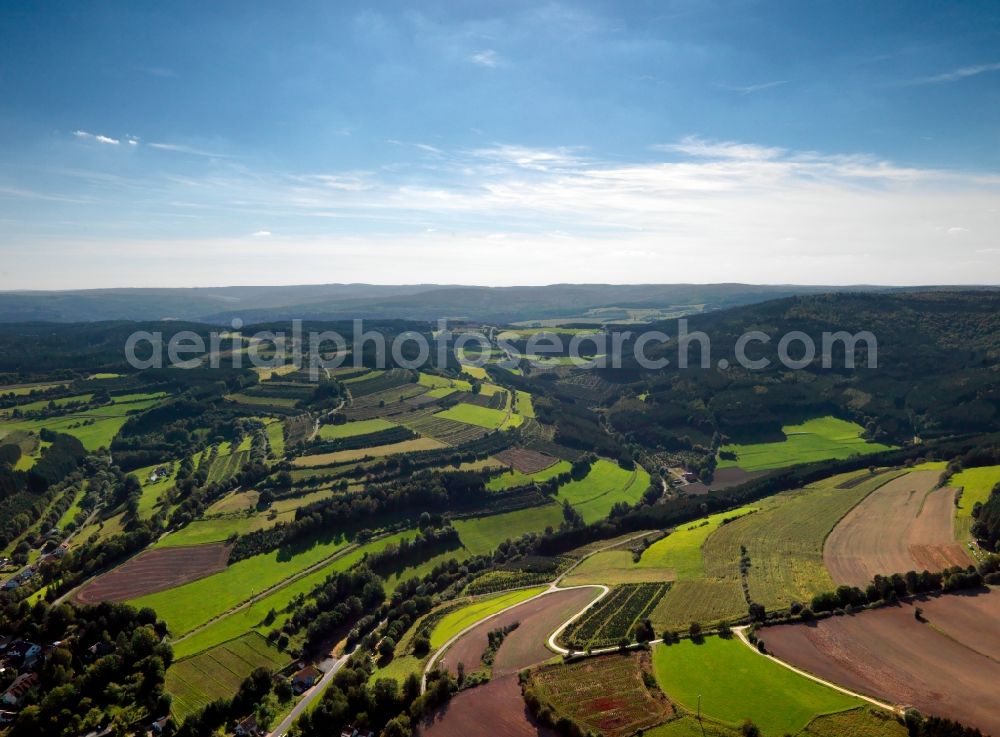 Aerial image Mittelsinn - The Spessart region in the borough of Mittelsinn in the state of Bavaria. The region is characterised by its hills, where fields are located in almost a terrace like fashion. The Spessart region is a mountain range in Southern Germany in the states of Bavaria and Hesse. The Spessart was used as a royal hunting ground, but today it is mostly important for the local tourism and as a recreational region. The region consists of 2440 square kilometres