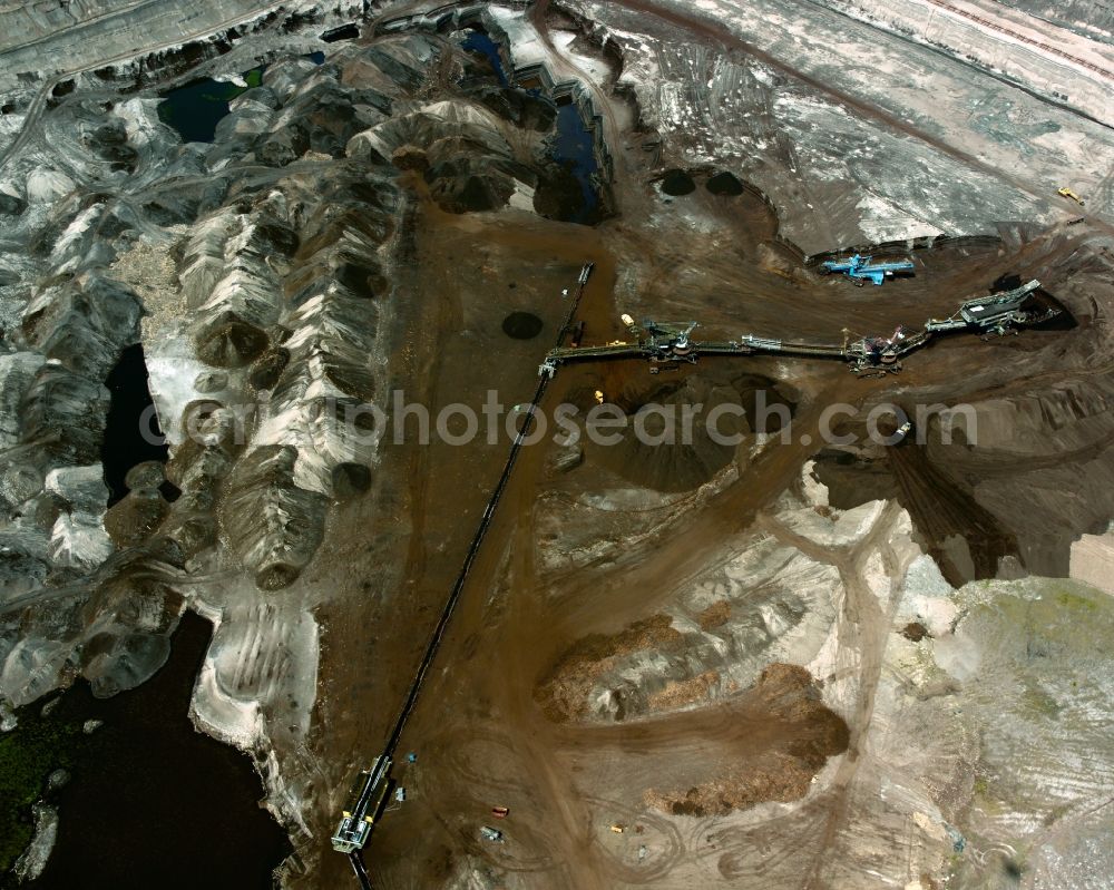 Aerial photograph Amsdorf - The opencast pit in the central German brown coal field in the state of Saxony-Anhalt. The compound belongs to ROMONTA GmbH. The facility is especially rich with Bitumen. The soft coal is extracted with bucket and bucket wheel excavators