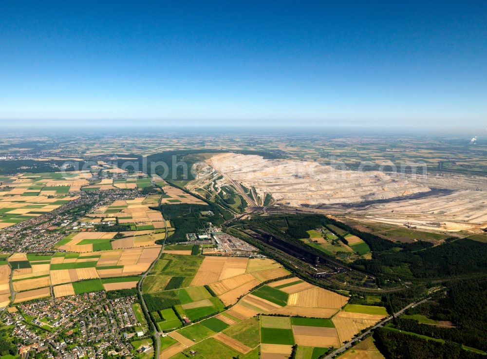 Elsdorf from the bird's eye view: The opencast pit Hambach in Elsdorf in the Rhine area of North Rhine-Westphalia. The area is run by RWE Power AG: It is primarily used for excavating brown and soft coal. The area includes the county district Niederzier, Kreis Düren and Elsdorf. The pit and mine is often reason for the relocation of villages. Parts of the largest wooded area of the state were destroyed and old settlements such as Manheim or Etzweiler had to be relocated