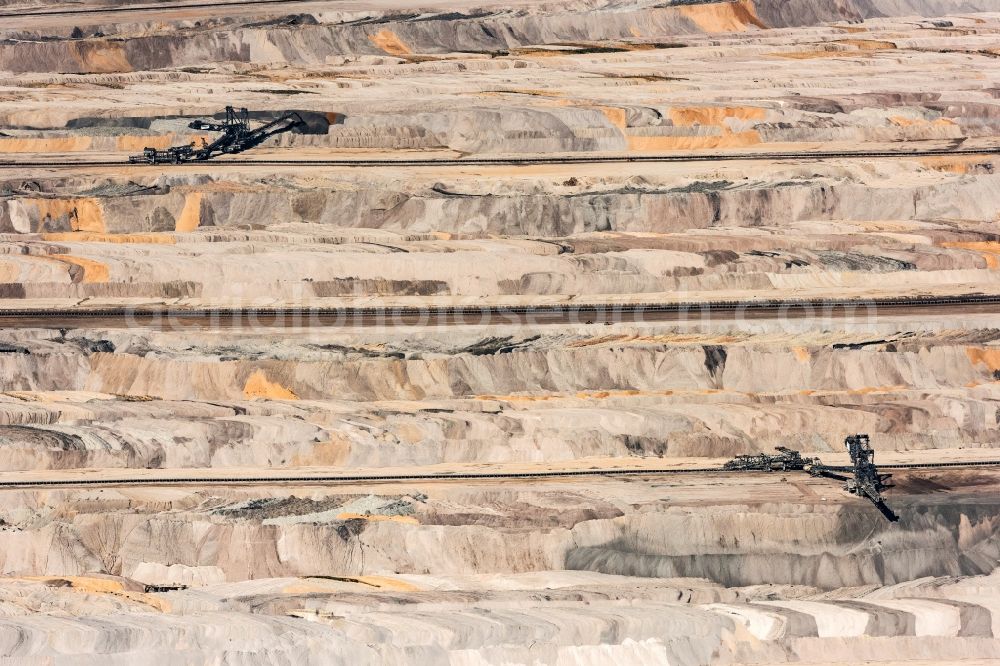 Elsdorf from the bird's eye view: The opencast pit Hambach in Elsdorf in the Rhine area of North Rhine-Westphalia. The area is run by RWE Power AG: It is primarily used for excavating brown and soft coal. The area includes the county district Niederzier, Kreis Dueren and Elsdorf. The pit and mine is often reason for the relocation of villages. Parts of the largest wooded area of the state were destroyed and old settlements such as Manheim or Etzweiler had to be relocated