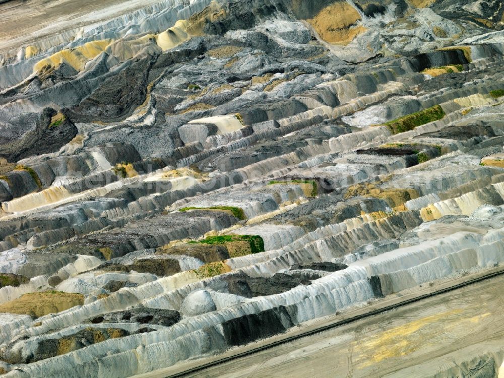 Inden from the bird's eye view: Brown coal mining near Inden in North Rhine-Westphalia. The opencast pit is part of RWE Power AG and used to excavate brown coal. It is close to the village of Inden in the Rhine brown coal area. The site is located between the county of Aldenhoven and the Autobahn A 44