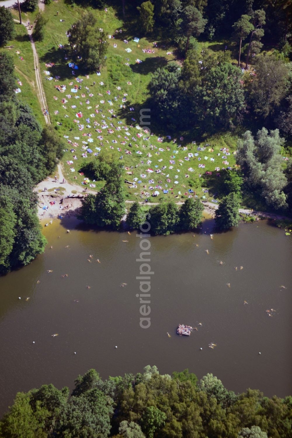 Berlin from above - The lake Teufelssee in the Grunewald forest area in the district of Charlottenburg - Wilmersdorf in Berlin in the state of Brandenburg. The lake is part of the nature reserve and wildlife sanctuary of Teufelsfenn, its south shore is a swimming area and holiday destination