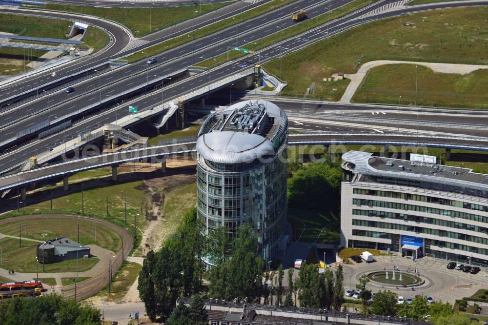 Warschau from above - The Trinity Park II office buildings in Sluzewiec in the Mokotow district of Warsaw in Poland. The complex consists of the round South building and the semicircular lower North building. It is run by DTZ and Emporis. The Southern building is home to offices of the PNB Paribas Bank. The compound is directly adjacent to the traffic junction of the S79 Expressway, which was completed in 2013 and is a spur route connecting inner-city roads