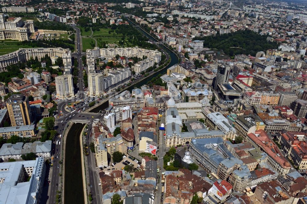 Aerial image Bukarest - The run of the river Dambovita in the city center of Bucharest in Romania. The river is regulated in the urban area. On its Southern riverbank there is the Parliament Palace, the largest building in Europe. The National History Museum with its two glas domes and the main building of the national savings bank CEC, the CEC palace, are located on the Northern riverbank