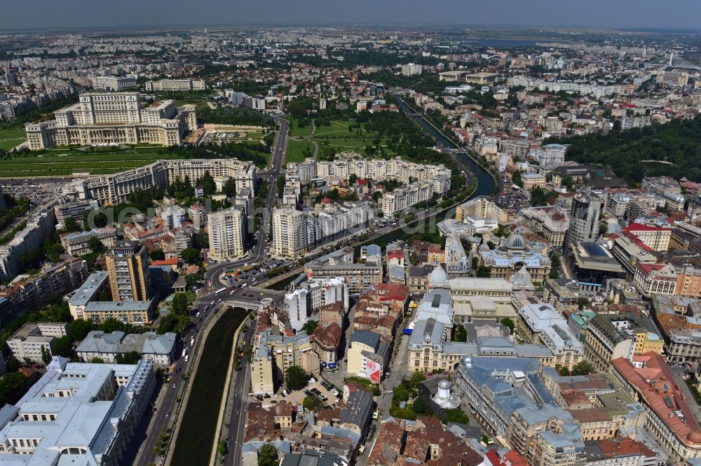 Bukarest from above - The run of the river Dambovita in the city center of Bucharest in Romania. The river is regulated in the urban area. On its Southern riverbank there is the Parliament Palace, the largest building in Europe. The National History Museum with its two glas domes and the main building of the national savings bank CEC, the CEC palace, are located on the Northern riverbank