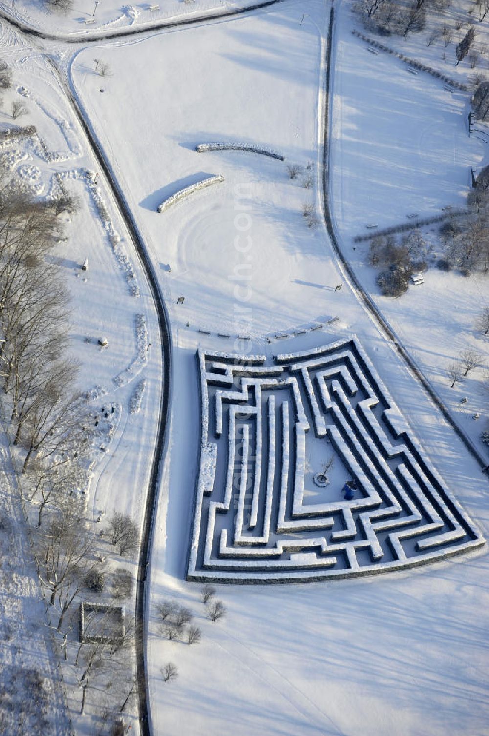 Berlin from the bird's eye view: Blick auf den Irrgarten im Erholungspark Marzahn. Das winterlich verschneite Labyrinth im Erholungspark Marzahn liegt im Berliner Bezirk Marzahn-Hellersdorf am nördlichen Fuß des Kienbergs. 2005 wurde der Chinesische Garten im Erholungspark Marzahn als drittschönste Parkanlage Deutschlands ausgezeichnet. Wintry Labyrinth area of the Marzahn Recreational Park.