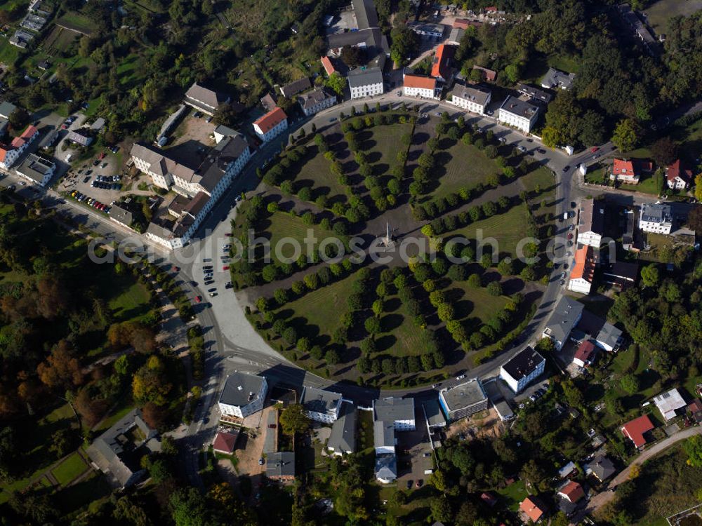 Aerial image Putbus - View of the central Circus square in Putbus. Neoclassical buildings line this circular space where all streets run together. A strictly structured parking facility fills the inner ring of the square, the center by a towering obelisk is marked