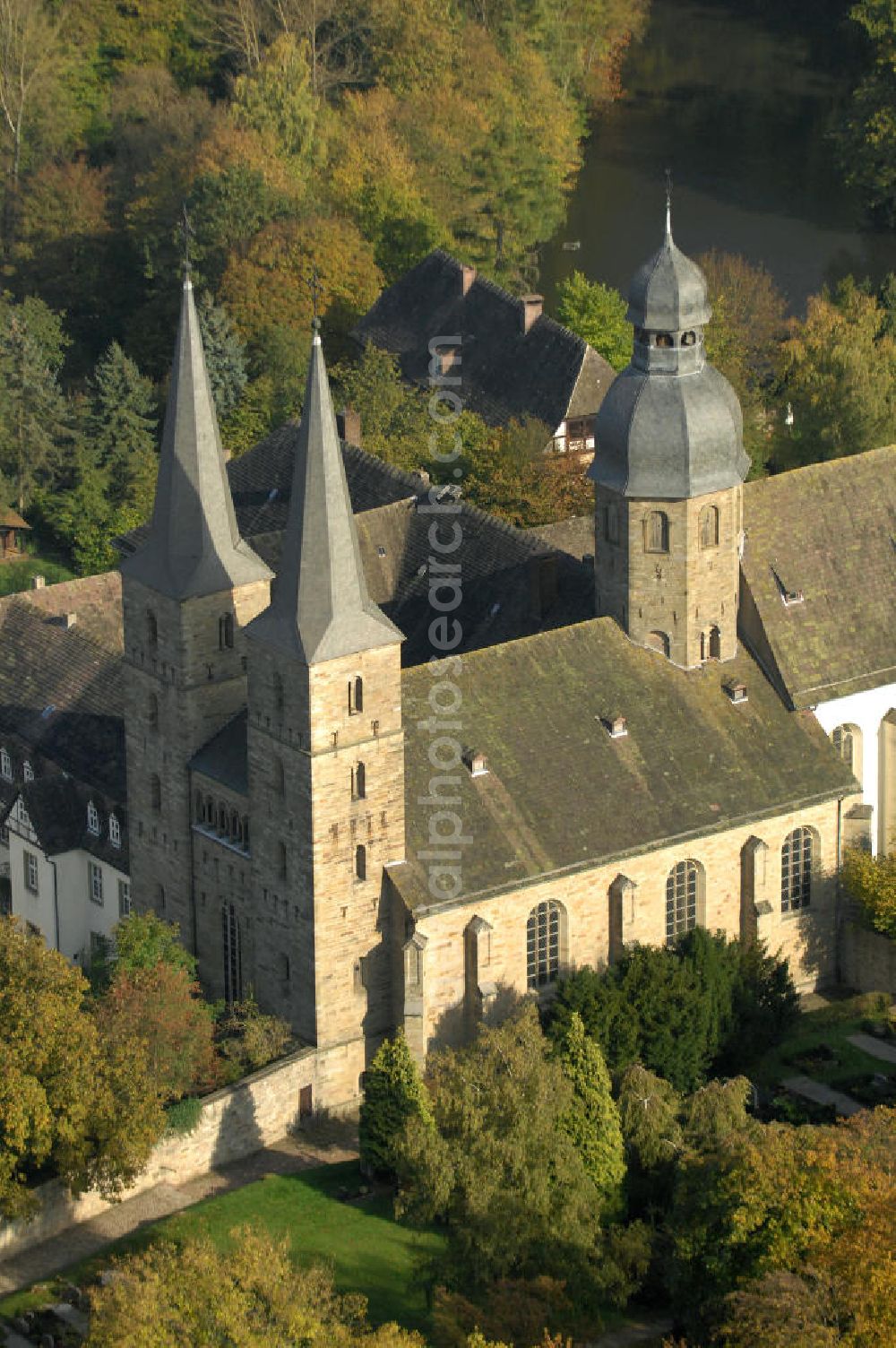 Marienmünster from the bird's eye view: Blick auf die Abtei Marienmünster. Das ehemalige Benediktinerkloster liegt in Nordrhein-Westfahlen. Erbaut wurde es 1127 bis 1128 durch Graf Widekind I. von Schwalenberg. Im Jahr 1803 wurde das Kloster aufgelöst, doch seit 1965 leben dort die Passionisten. Während des 30jährigen Krieges wurde das Kloster weitgehend zerstört, doch im Jahr 1661 wieder Aufgebaut, mehrere Umbauten führten dazu, dass das Gebäude sowohl romanische, barocke als auch gotische Elemente besitzt. Seit 2006 sorgt eine Stiftung dafür, dass das Gebäude aufwendig restauriert wird. Kontakt: Stadt Marienmünster, Schulstraße 1, 37696 Marienmünster, Tel. 05276/9898-0, info@marienmuenster.de