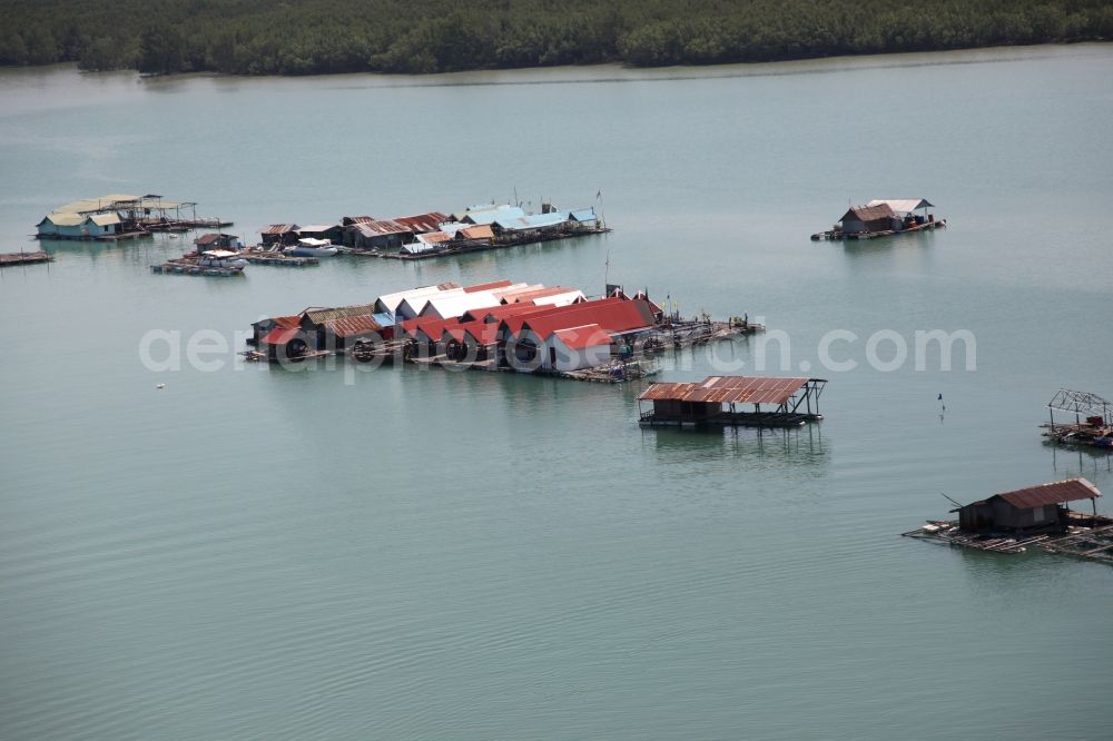 Ratsada from the bird's eye view: The Bay Ao Tha Rua in front of the city Ratsada on the island Phuket in Thailand is full of floating fish farms with accompanying boats and houseboats