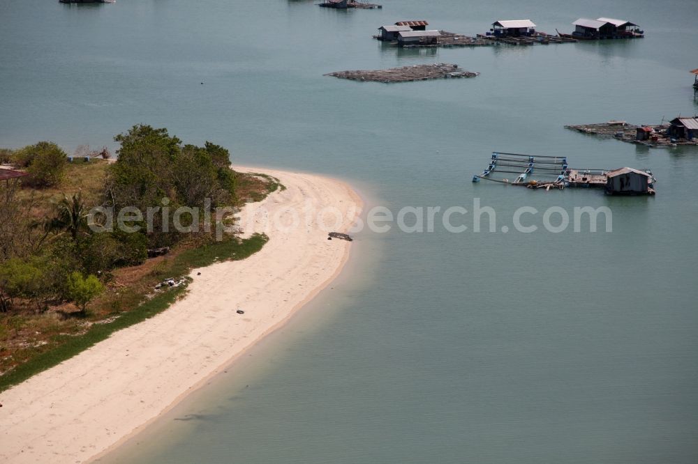 Aerial image Ratsada - The Bay Ao Tha Rua in front of the city Ratsada on the island Phuket in Thailand is full of floating fish farms with accompanying boats and houseboats