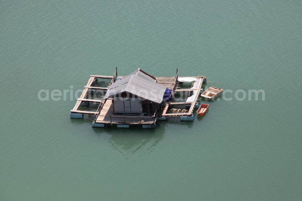 Aerial photograph Ratsada - The Bay Ao Tha Rua in front of the city Ratsada on the island Phuket in Thailand is full of floating fish farms with accompanying boats and houseboats