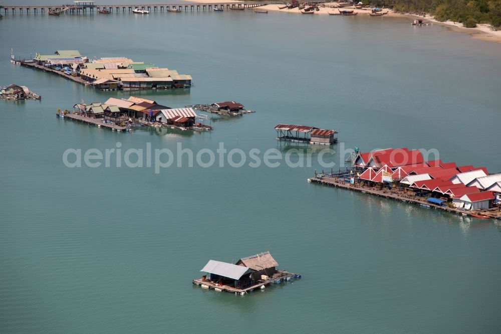 Ratsada from above - The Bay Ao Tha Rua in front of the city Ratsada on the island Phuket in Thailand is full of floating fish farms with accompanying boats and houseboats