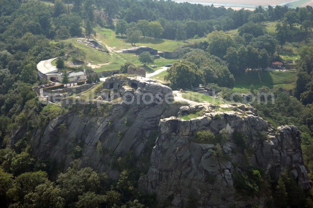 Aerial photograph Blankenburg - Die Burgruine Regenstein liegt 3 km nördlich von Blankenburg in Sachsen-Anhalt und ist ein beliebtes Ausflugsziel, auf dem jedes Jahr ein Ritterspiel und ein Garnisonsfest stattfinden. Hervorzuheben sind einige in den Fels hineingehauene Räume und die Ruine des Bergfrieds.