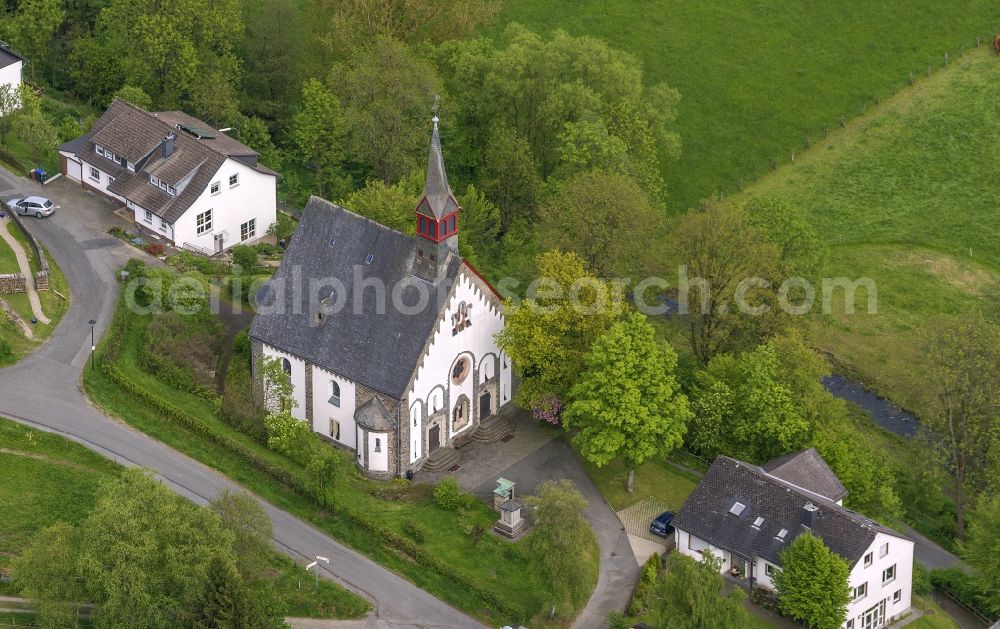 Aerial image Bad Berleburg - The evangelical church Wemlighausen in the Wemlighausen part of the town of Bad Berleburg in the state of North Rhine-Westphalia. The listed church building is built in a new romanic style