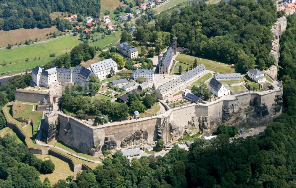 Königstein from above - The Fortress Koenigstein at the river Elbe in the county district of Saxon Switzerland East Erzgebirge in the state of Saxony. The fortress is one of the largest mountain fortresses in Europe and is located amidst the Elbe sand stone mountains on the flat top mountain of the same name. In front of it, the river runs through a valley