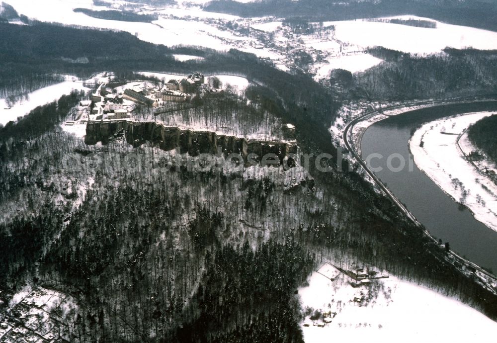 Königstein from above - The fortress Koenigstein in Saxon Switzerland in winter with snow in Saxony. It is one of the most architecturally and historically most charming mountain fortresses in Europe