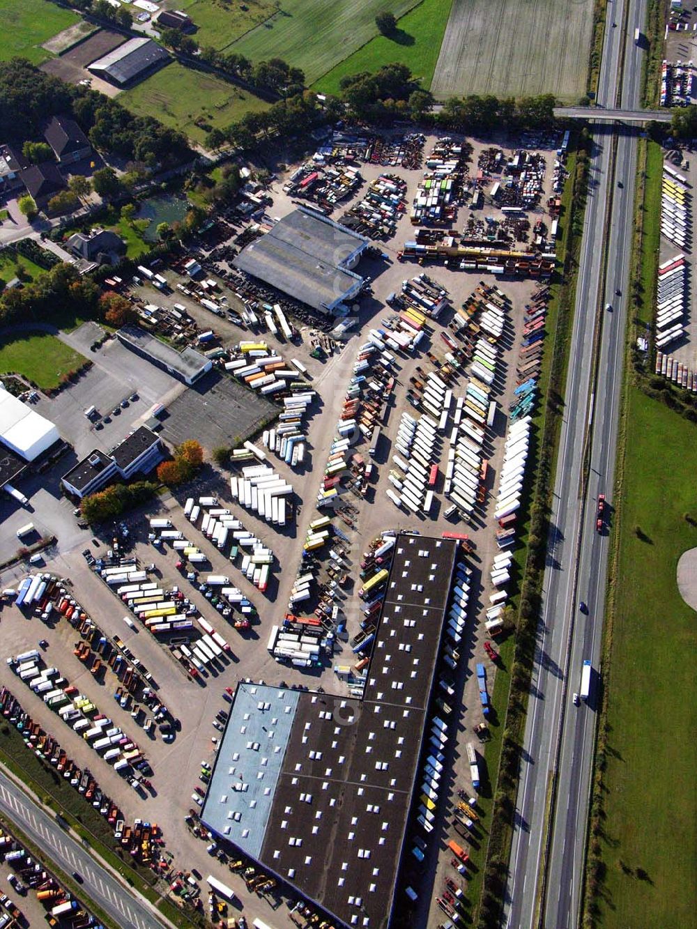 Aerial image Sittensen - 18.10.2005 Sittensen; Die Firma Alga betreibt seit über 30 Jahren in Sittensen an der A1 einen Nutzfahrzeughandel, auf ca. 400.000 m² Lagerfläche werden mehr als 3000 Einheiten vorgehalten. Ergänzt wird die Angebotspalette durch einen Reifengroßhandel und Service, durch Werkstatt, Lackiererei und Ersatzteillager.