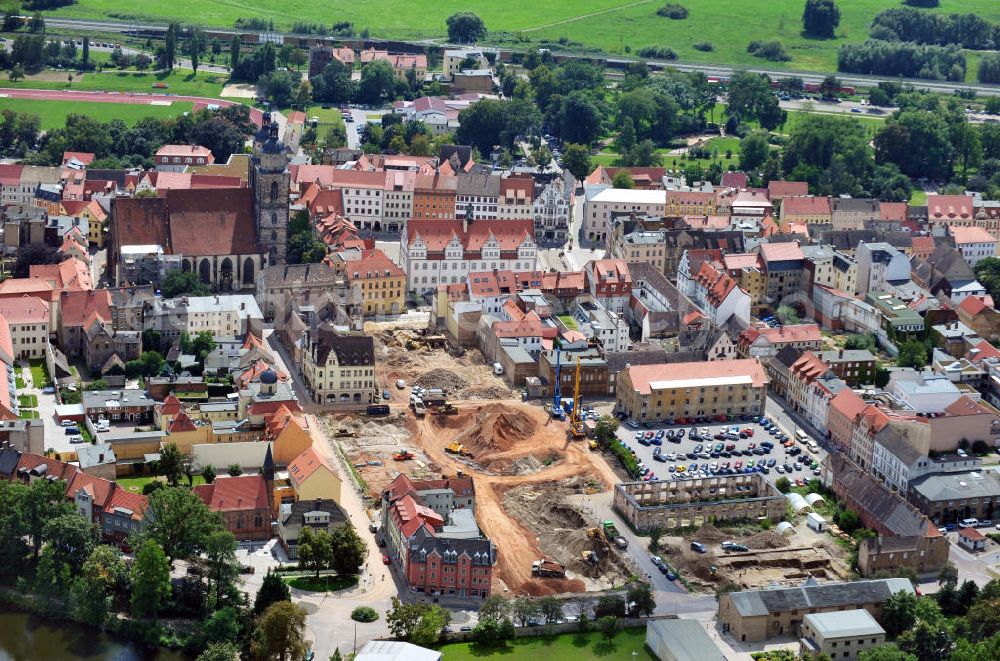 Aerial photograph Wittenberg - View of the construction site of the shopping center Arsenal between the Arsenal square and the market place in the inner city of Wittenberg. Project developers are MIB AG and the OFB Development GmbH. The completion is scheduled for autumn 2012