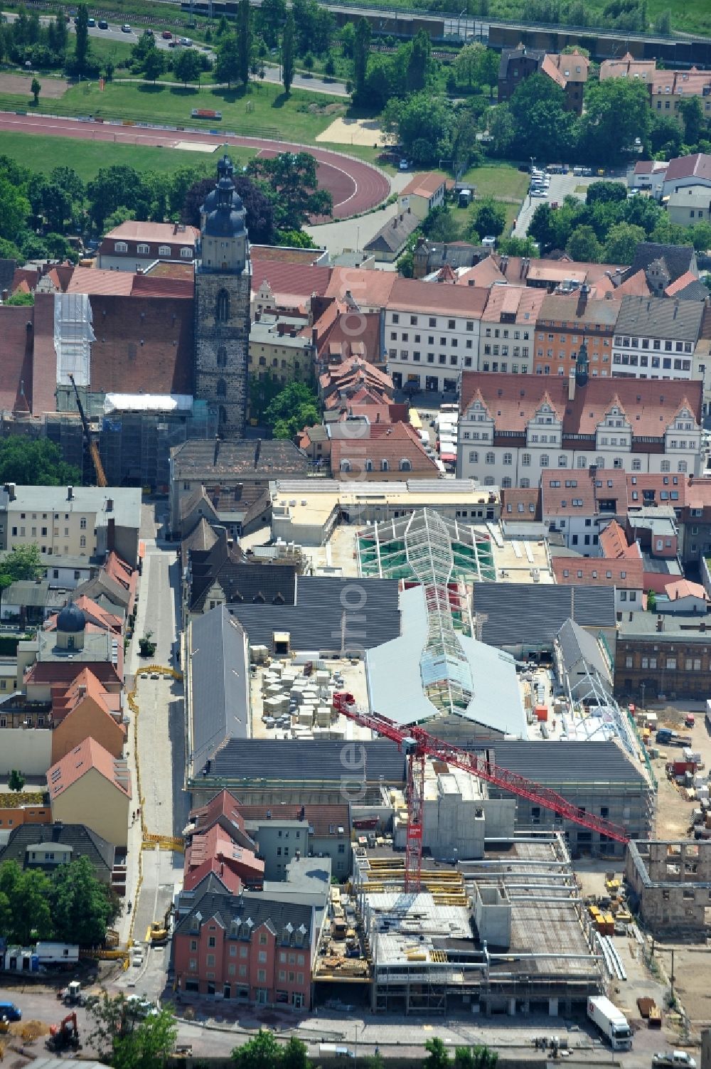 Aerial photograph Wittenberg - View of the construction site of the shopping center Arsenal between the Arsenal square and the market place in the inner city of Wittenberg. Project developers are MIB AG and the OFB Development GmbH. The completion is scheduled for autumn 2012