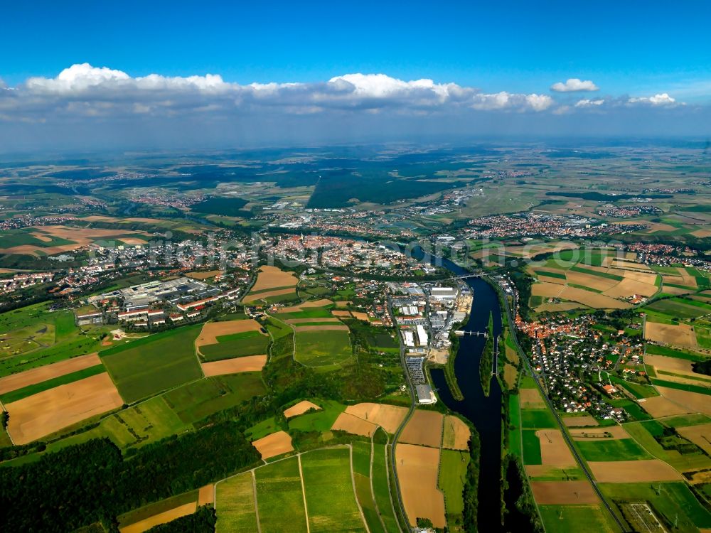 Kitzingen from above - The large district capital of Kitzingen in the Mainfranken region in the state of Bavaria. The surrounding landscape of the town is characterised by agriculture and fields. It is located on both sides of the river Main, which is crossed by several bridges. The historic city center and the industrial and commercial area of the town are located on its eastside