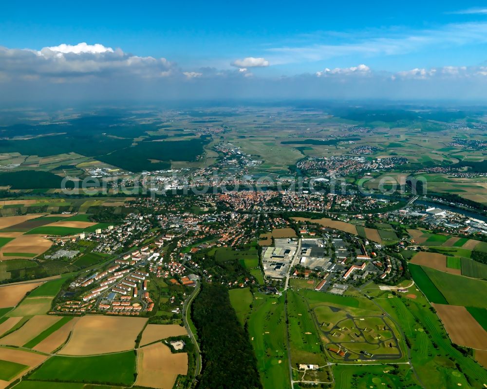 Kitzingen from the bird's eye view: The large district capital of Kitzingen in the Mainfranken region in the state of Bavaria. The surrounding landscape of the town is characterised by agriculture and fields. It is located on both sides of the river Main, which is crossed by several bridges. The historic city center and the industrial and commercial area of the town are located on its eastside