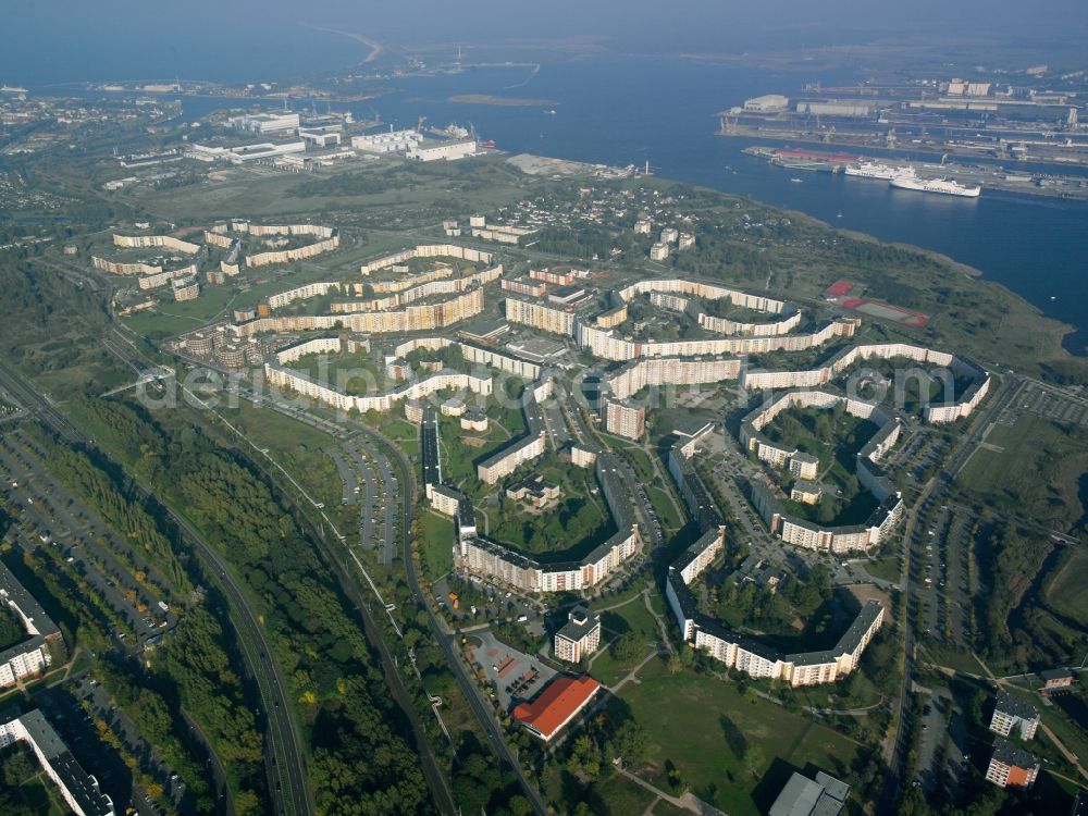 Rostock from the bird's eye view: The large housing estate in the Groß Klein part in the North West of Rostock in the state of Mecklenburg-Vorpommern. The estate was built in the 1980s as the last of 5 residential estates in the area. It was part of the housing programme of the GDR and made with precast concrete slabs. It is located opposite the harbour of Rostock