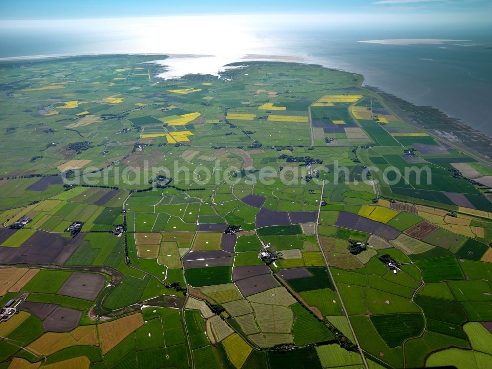 Aerial image Eiderstedt - The peninsula of Eiderstedt in the state of Schleswig-Holstein. Eiderstedt is located in the county district of Nordfriesland and was created through land reclamation including two islands and a peninsula. It is enclosed by the Wadden Sea and is favoured by tourists. Visible are the Wadden Sea and the shores as well as fields that are important for the local agriculture