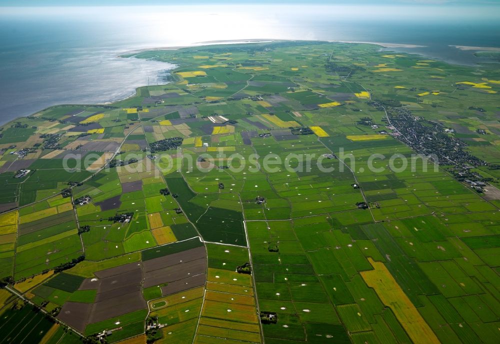 Aerial photograph Eiderstedt - The peninsula of Eiderstedt in the state of Schleswig-Holstein. Eiderstedt is located in the county district of Nordfriesland and was created through land reclamation including two islands and a peninsula. It is enclosed by the Wadden Sea and is favoured by tourists. Visible are the Wadden Sea and the shores as well as fields that are important for the local agriculture