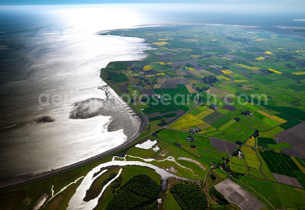 Eiderstedt from above - The peninsula of Eiderstedt in the state of Schleswig-Holstein. Eiderstedt is located in the county district of Nordfriesland and was created through land reclamation including two islands and a peninsula. It is enclosed by the Wadden Sea and is favoured by tourists. Visible are the Wadden Sea and the shores as well as fields that are important for the local agriculture