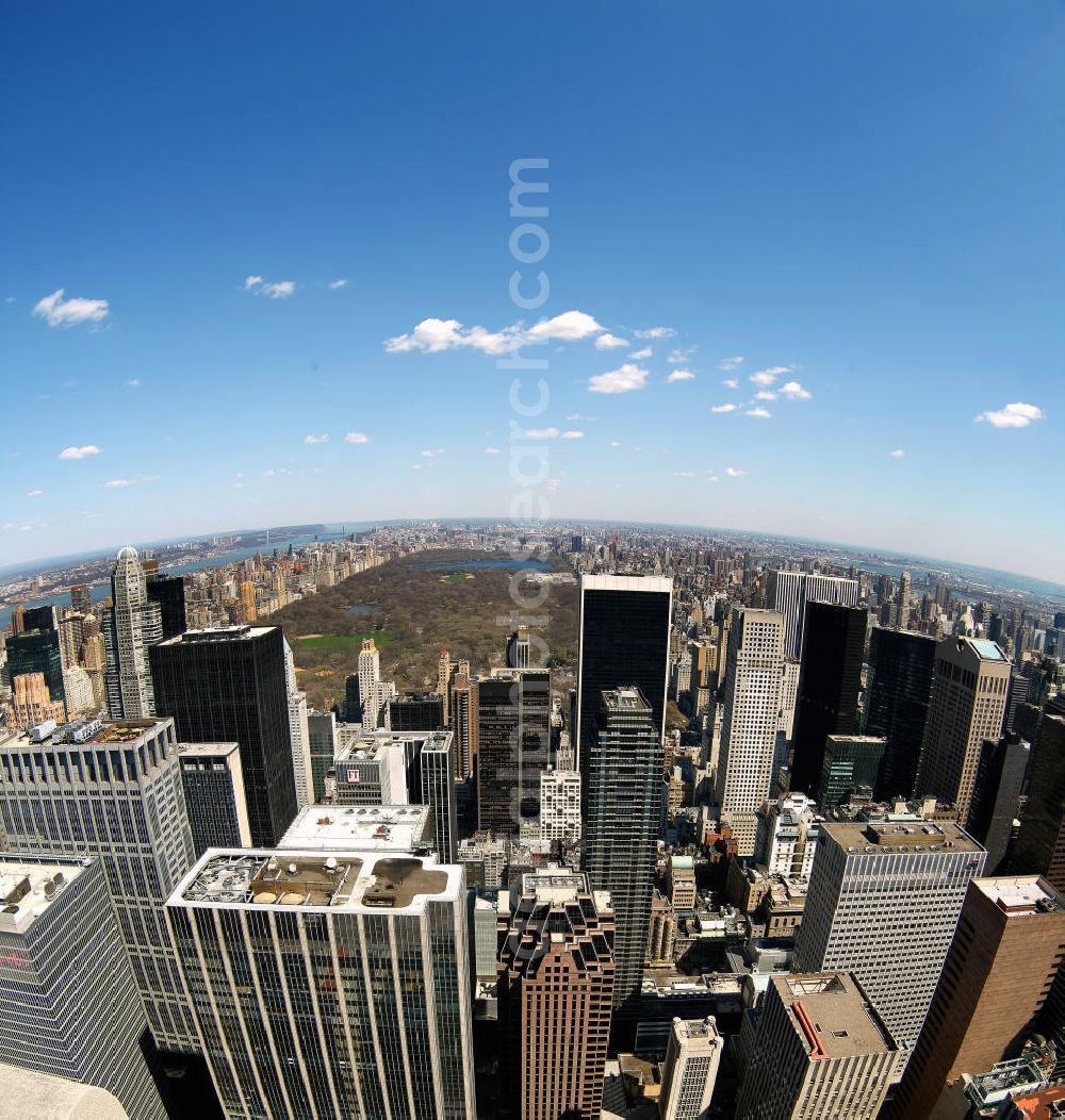 New York from above - Fish-eye view of the skyscrapers of the Midtown Center of Manhattan to New York's Central Park. This park was established in 1853 and is used ever since as a public park