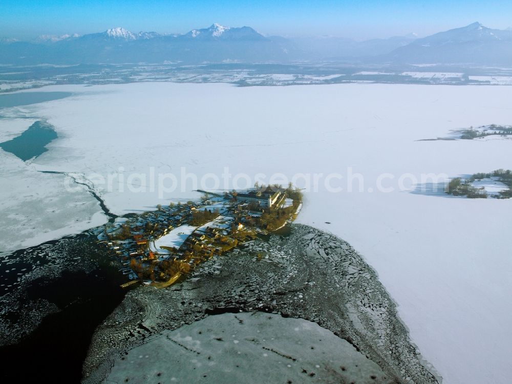 Frauenchiemsee from the bird's eye view: The island Frauenchiemsee in the lake Chiemsee in the state of Bavaria. The island is car free and reachable via ship throughout the year. The island is snow covered and the lake is frozen