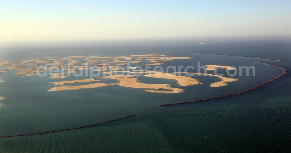 Aerial image Dubai - The islands of The World just off the coast of Dubai in the United Arab Emirates consists of about three hundred man-made islands. The giant project threatens to become a flop. Since 2011, the construction works rest. Only two islands are completed and inhabited