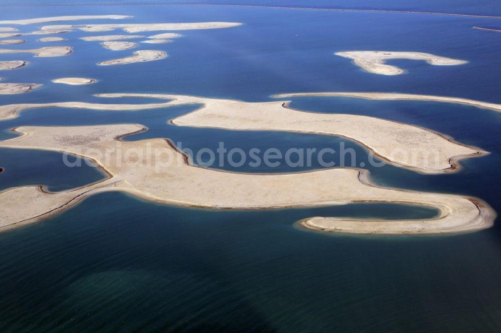 Dubai from above - The islands of The World just off the coast of Dubai in the United Arab Emirates consists of about three hundred man-made islands. The giant project threatens to become a flop. Since 2011, the construction works rest. Only two islands are completed and inhabited