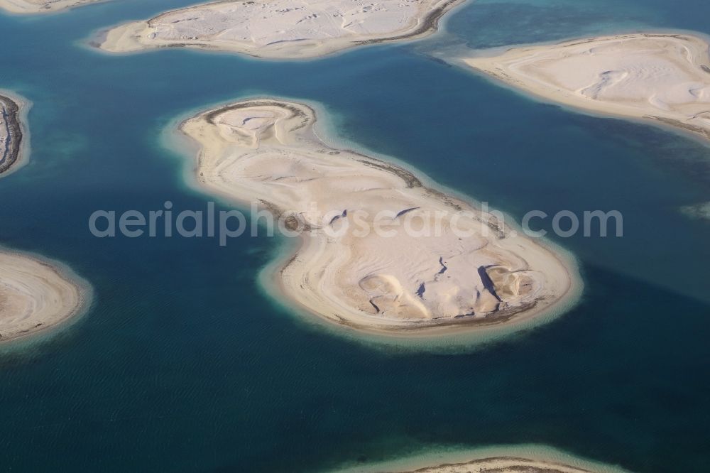 Dubai from above - The islands of The World just off the coast of Dubai in the United Arab Emirates consists of about three hundred man-made islands. The giant project threatens to become a flop. Since 2011, the construction works rest. Only two islands are completed and inhabited