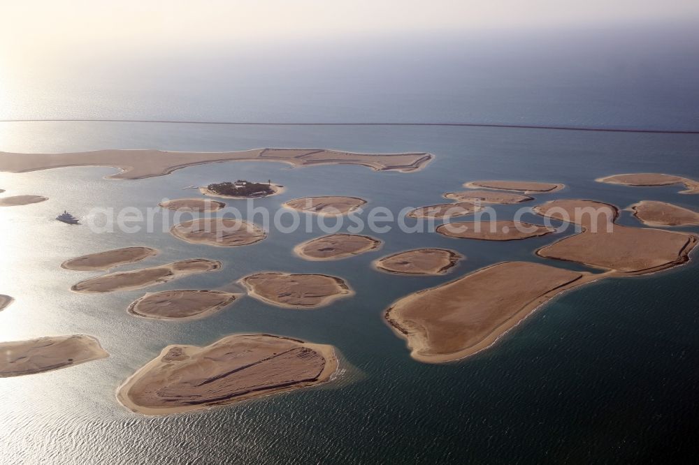 Aerial image Dubai - The islands of The World just off the coast of Dubai in the United Arab Emirates consists of about three hundred man-made islands. The giant project threatens to become a flop. Since 2011, the construction works rest. Only two islands are completed and inhabited