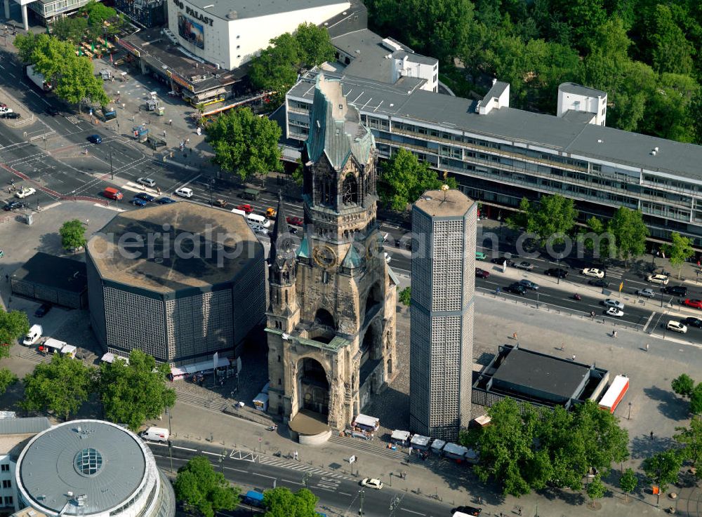 Aerial photograph Berlin - The Protestant Kaiser William Memorial Church (colloquially known Memorial Church and in Berlin dialect called Hollow Tooth) is located at Breitscheidplatz between the Kurfürstendamm, the Tauentzienstraße and the Budapest street in Berlin's Charlottenburg district. The resulting lobby of the former church is now a museum and war memorial