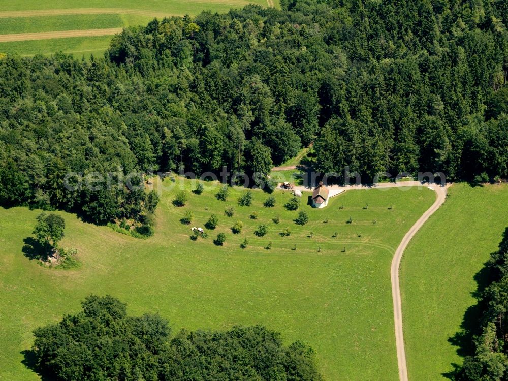 Eggingen from the bird's eye view: The chapel is located outside the municipality. There is a single-standing building, located at one edge of the forest. The site is across a street to reach road