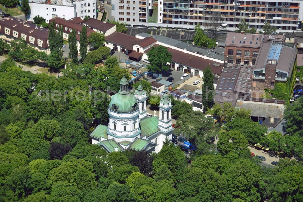 Aerial photograph Warschau - The Saint Charles Borromäus Church in the Powazki district of Warsaw in Poland. The church (Ko?ció? pw ?wi?tego Karola Boromeusza) was built in th 18th century and refurbished in the 19th century. During the Warsaw Resistance, it was destroyed. It was renovated in 1960 and with its dome and two towers rebuilt. The church is located on the compound of the Powazki cemetery, surrounded by forest and opposite a residential area