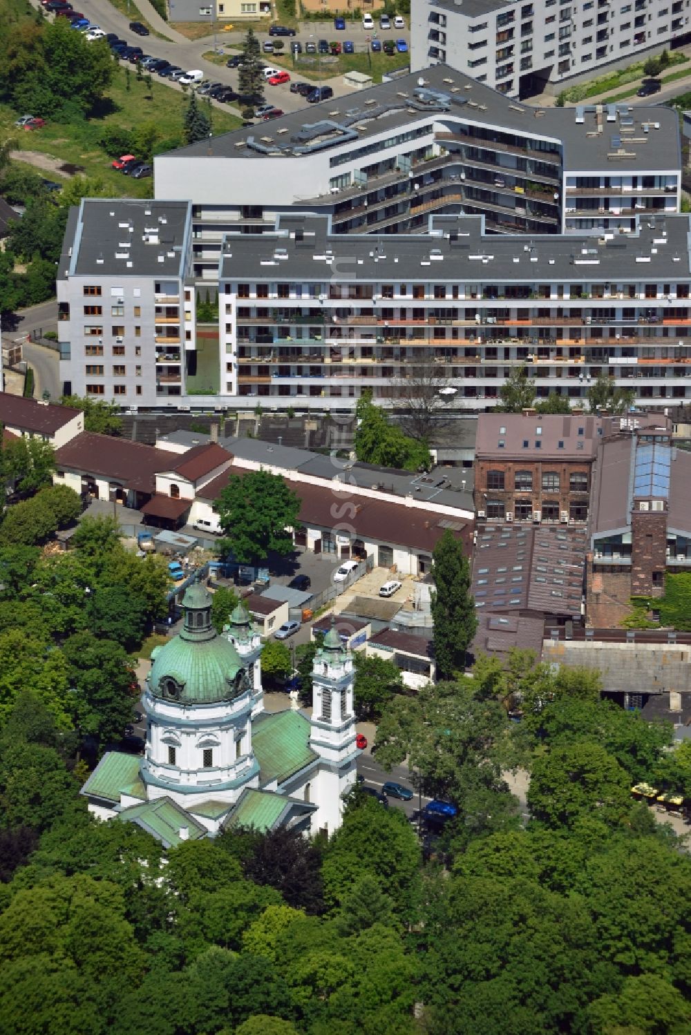 Warschau from above - The Saint Charles Borromäus Church in the Powazki district of Warsaw in Poland. The church (Ko?ció? pw ?wi?tego Karola Boromeusza) was built in th 18th century and refurbished in the 19th century. During the Warsaw Resistance, it was destroyed. It was renovated in 1960 and with its dome and two towers rebuilt. The church is located on the compound of the Powazki cemetery, surrounded by forest and opposite a residential area