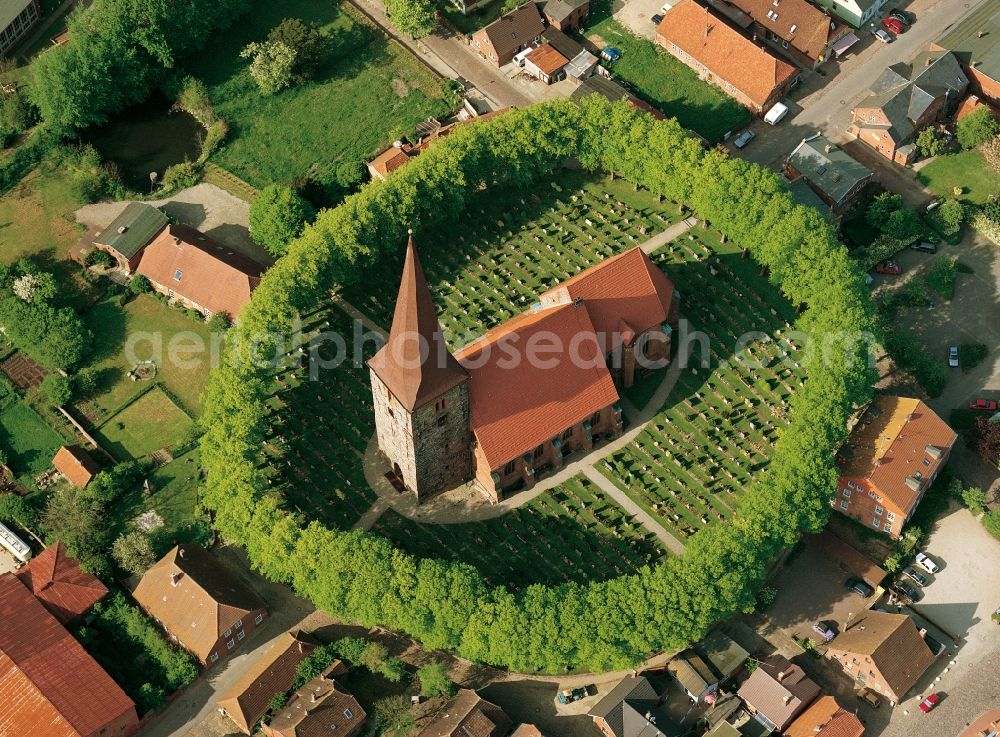 Aerial photograph Petersdorf - The Church in Petersdorf Fehmarn in Schleswig-Holstein. The church and its cemetery are located within a ring of trees