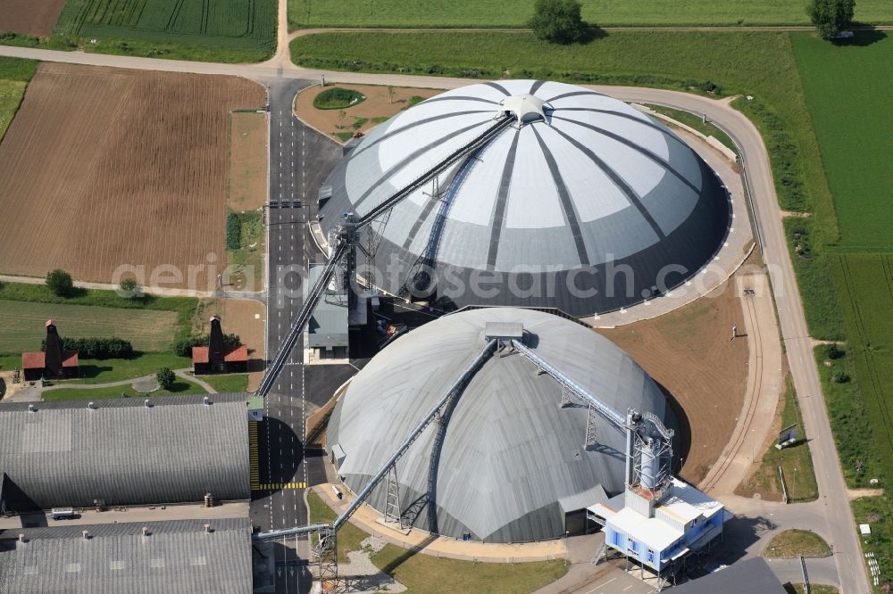 Rheinfelden from above - The domes and the operating area of the United Swiss Saltworks in Rheinfelden in Switzerland. The domes are built as a wooden structure and the larger is the largest domed structure in Europe. The circular arenas serve as a salt deposit for de-icing salt for winter maintenance. Built from wood technology company Haering 