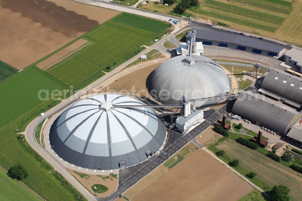 Aerial photograph Rheinfelden - The domes and the operating area of the United Swiss Saltworks in Rheinfelden in Switzerland. The domes are built as a wooden structure and the larger is the largest domed structure in Europe. The circular arenas serve as a salt deposit for de-icing salt for winter maintenance. Built from wood technology company Haering 