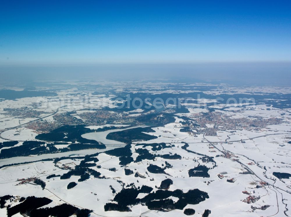 Schongau from above - The Lech Valley Bridge and its snow covered surroundings in Schongau and Peiting in the state of Bavaria. The bridge connects Schongau on the west shore of the river and Peiting on the East side. The building runs across the Lech barrier lake. The bridge accommodates the federal highways 17 and 472