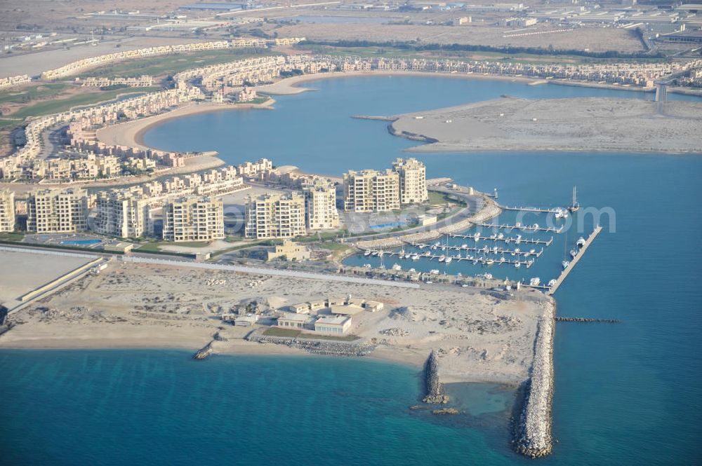 Aerial image Ras Al Khaimah - The Marina Apartments and the Al Hamra Marina Yacht Club in the arab emirate Ras Al Khaimah. The apartments and the yacht club are part of the Al Hamra Village Project, the second largest construction project of Ras Al Khaimah. The project is realized by the state-owned company Al Hamra Real Estate