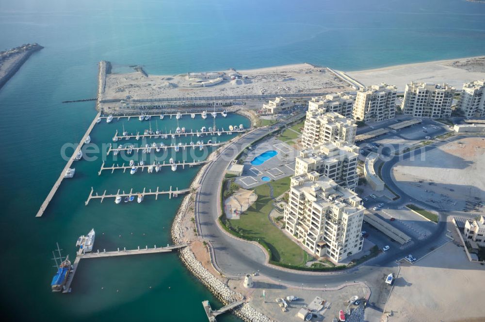 Ras Al Khaimah from above - The Marina Apartments and the Al Hamra Marina Yacht Club in the arab emirate Ras Al Khaimah. The apartments and the yacht club are part of the Al Hamra Village Project, the second largest construction project of Ras Al Khaimah. The project is realized by the state-owned company Al Hamra Real Estate